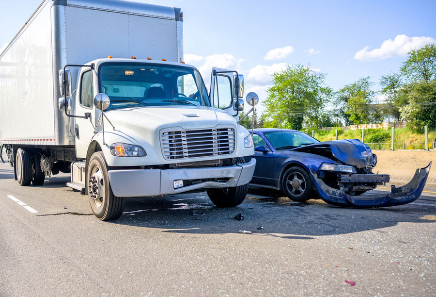 A semi-truck and car on the road after an accident.